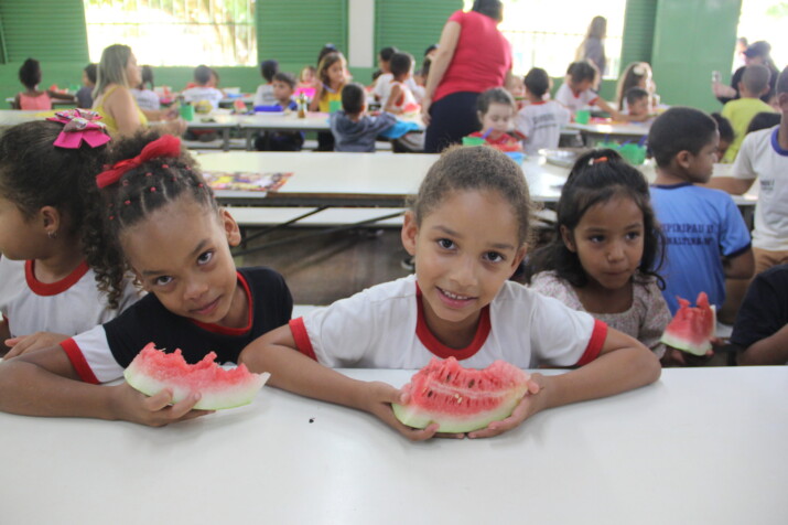 Children eating watermelon during school meal times.