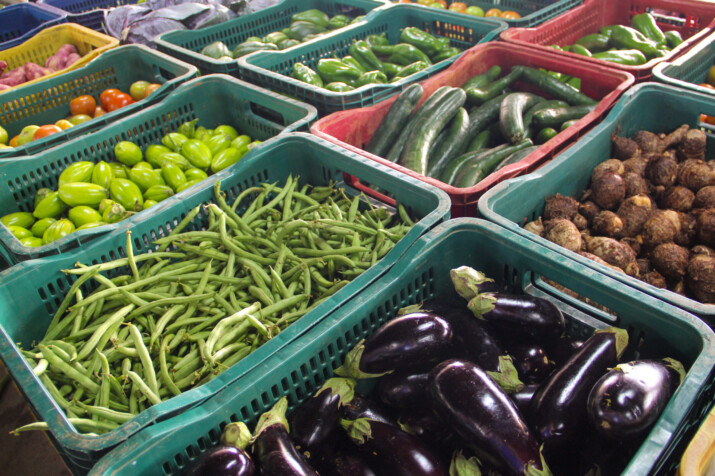 Frutas e legumes em caixotes de plástico verdes